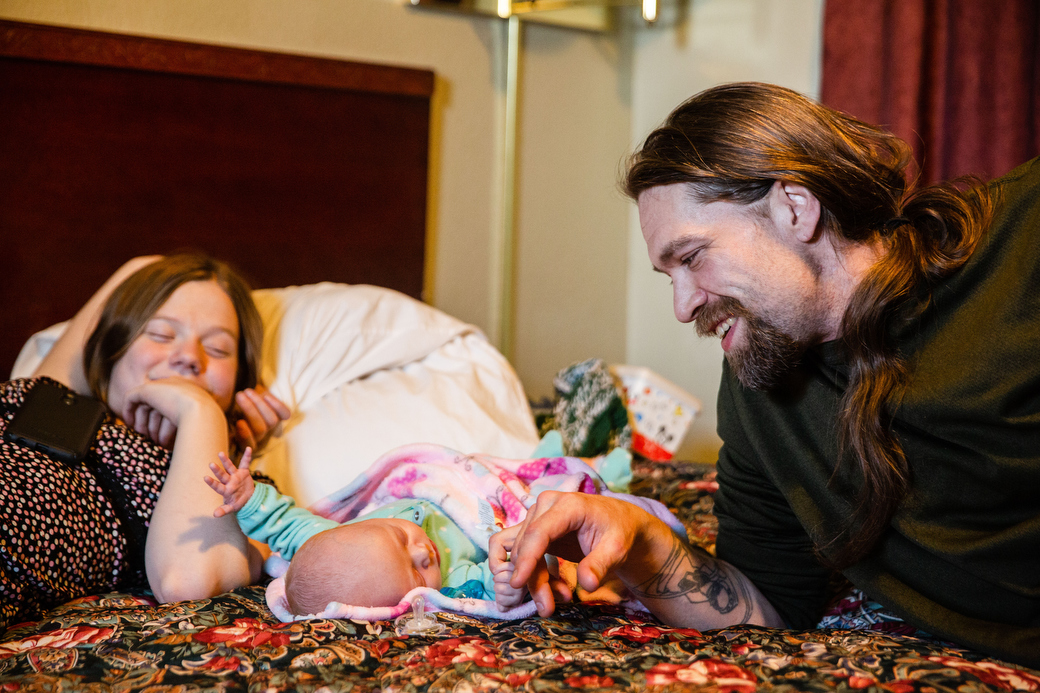  Ivy's boyfriend, Wayne Wallace, messes with Christina as she sleeps on their bed in the motel, Friday, Nov. 23, 2018. Ivy had a panic attack at the shelter because of how crowded it was and left, getting a voucher for a few days at a motel. The firs