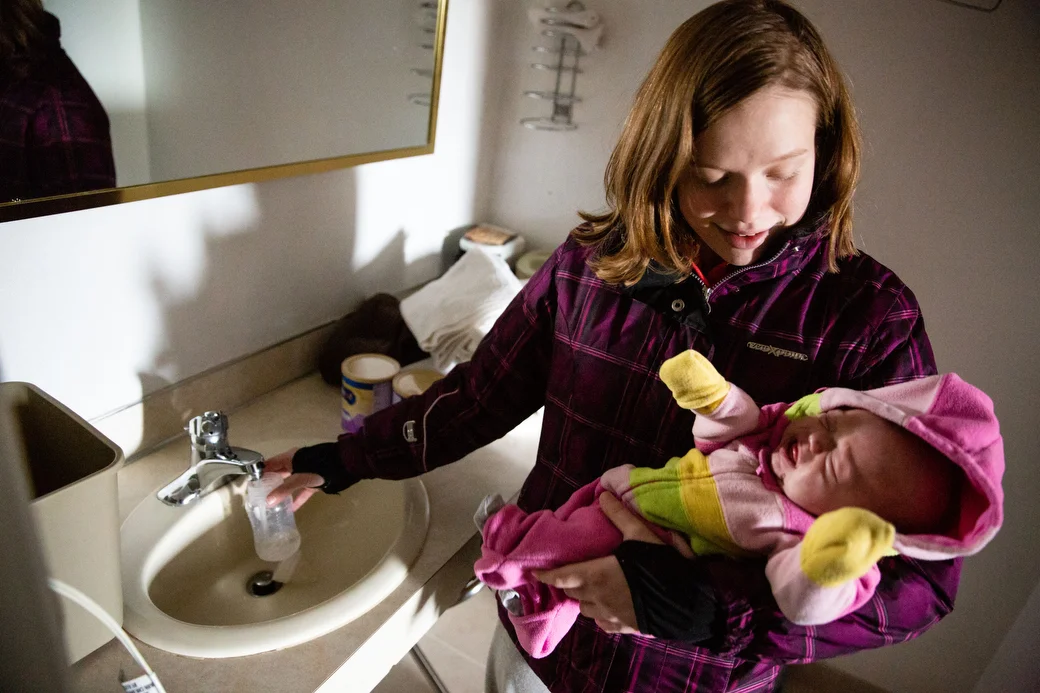  Ivy prepares a bottle for Christina in their room at the Chippewa Motel, Wednesday, Nov. 21, 2018. 