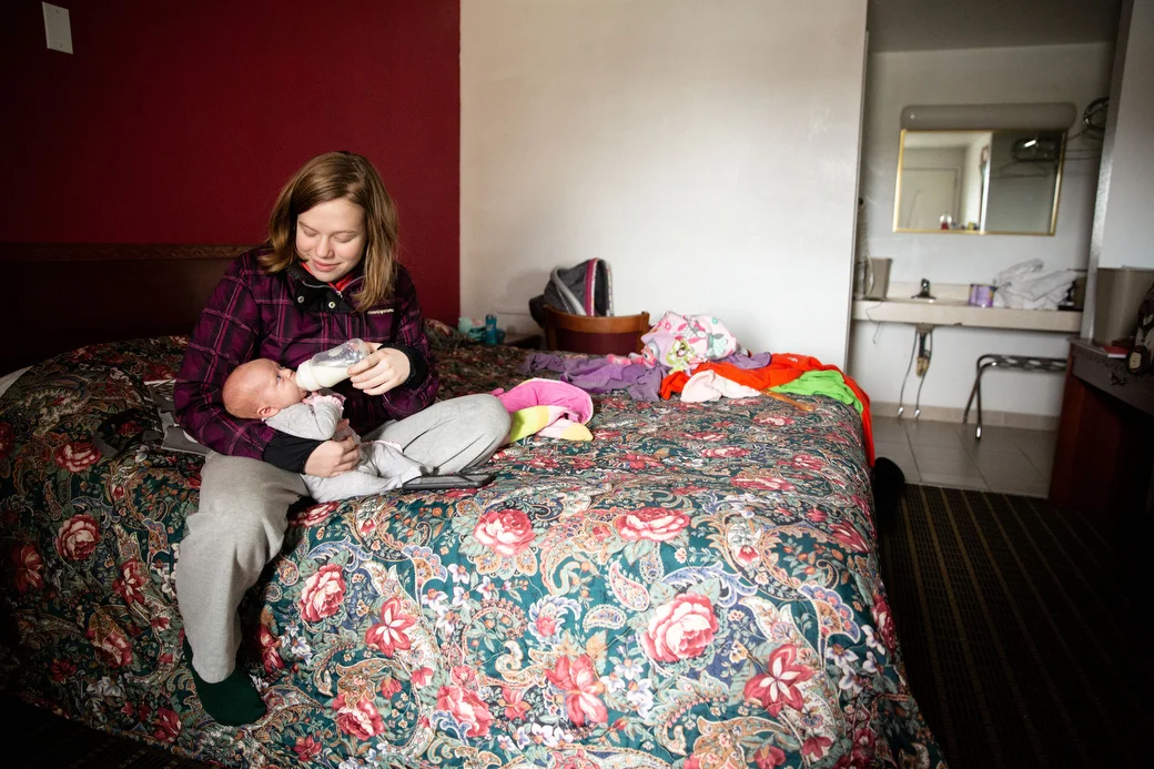  Ivy feeds Christina in their room in the Chippewa Motel, Wednesday, Nov. 21, 2018. Ivy and Wayne have been looking for an apartment to move into but Ivy explains it is challenging to find a place in the college town where many places prefer college 