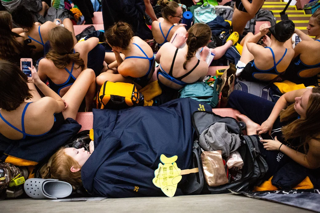  Girls on the Mount Pleasant High School Swim and Dive Team sit in the stands before warmups during the Saginaw Valley League Girls Swimming and Diving Championship Prelims, Thursday, Nov. 1, 2018 at Saginaw Valley State University. 