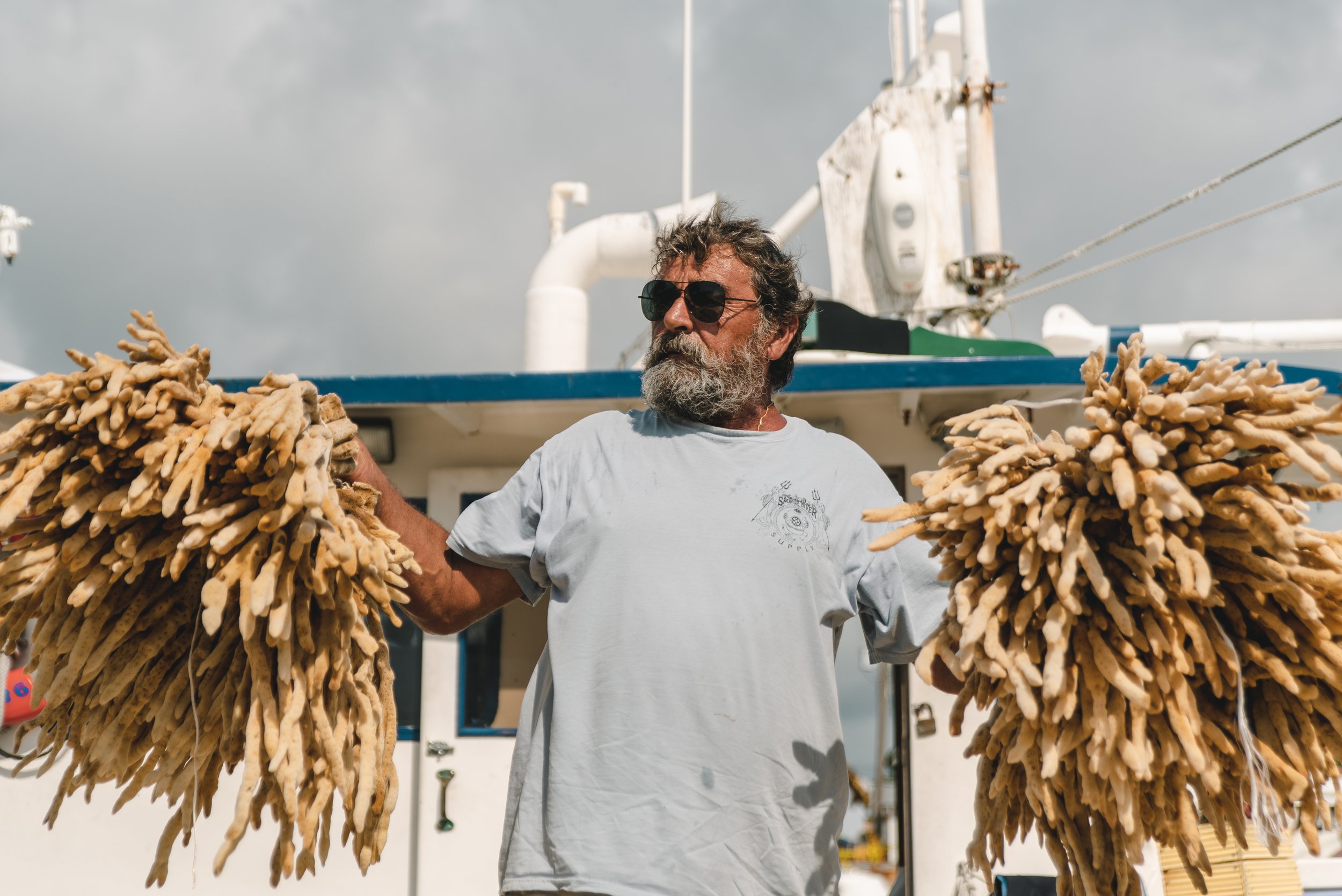 Taso displays the sponges that he acquired on a recent dive. Tarpon Springs, Florida