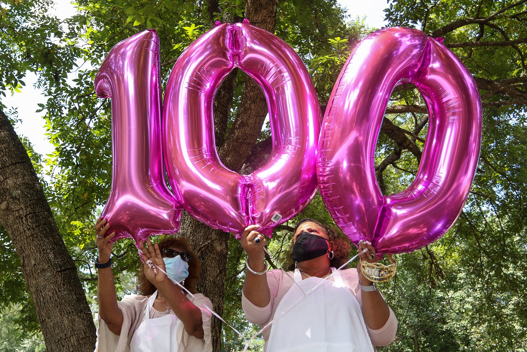 Mattie Price and Peggy Elder arrange balloons at their aunt Katherine Scott's 100th birthday celebration in Athens, Ga., on Saturday, Sept. 5, 2020. (Photo/Chamberlain Smith, Athens Banner-Herald)