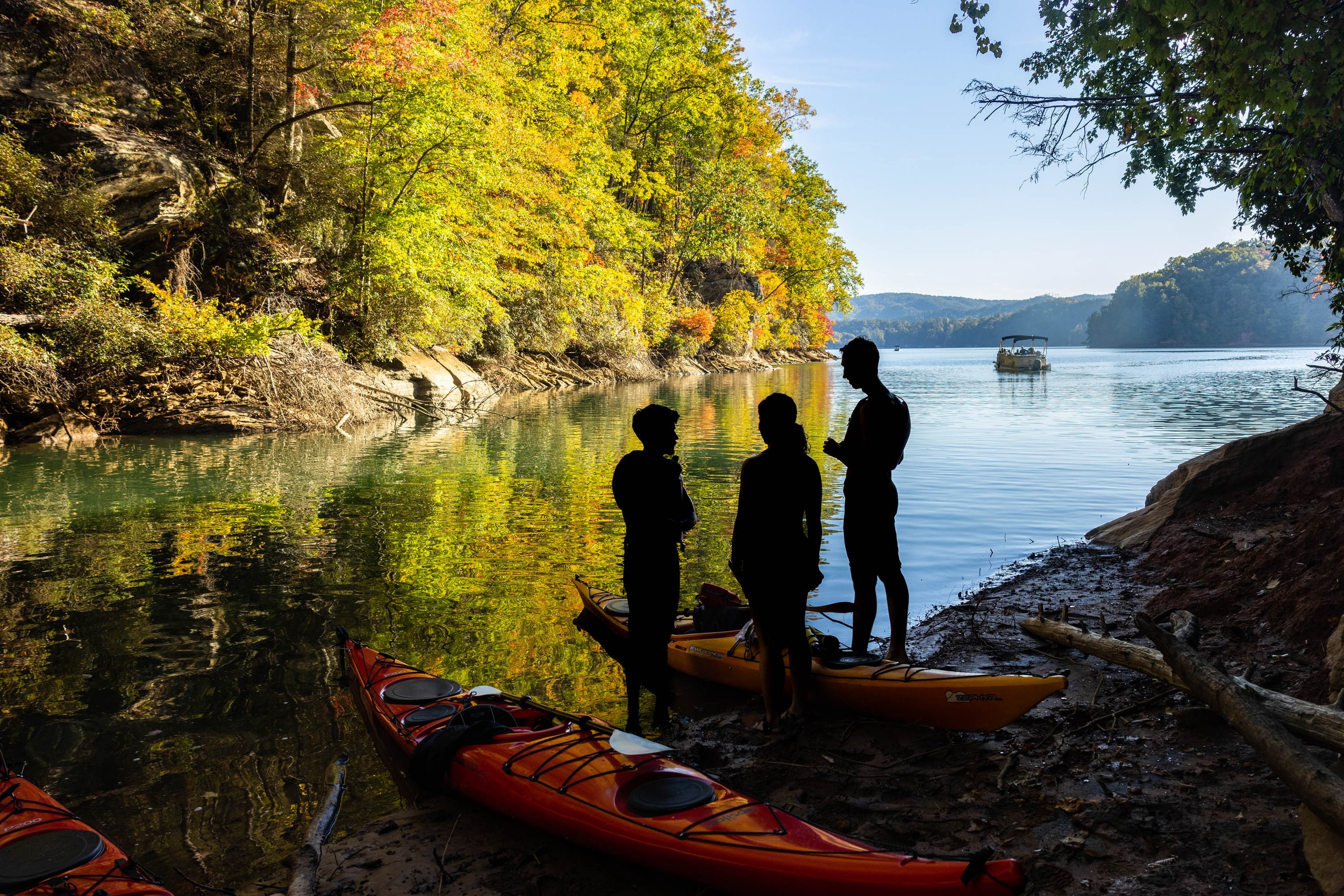 Students are silhouetted agains Lake Jocasse during a UGA Rec Sports trip to Devil’s Fork State Park in Salem, South Carolina, on October 22, 2022.
