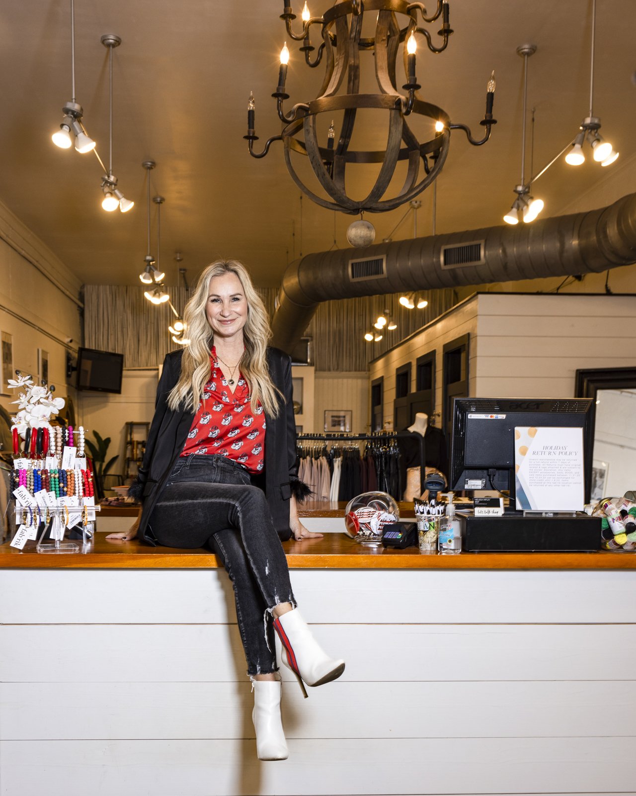 Dana Spinola, UGA alum and CEO of boutique franchise, Fab'rik, poses for a portrait at the location in downtown Athens, Ga., on December 8, 2022.
