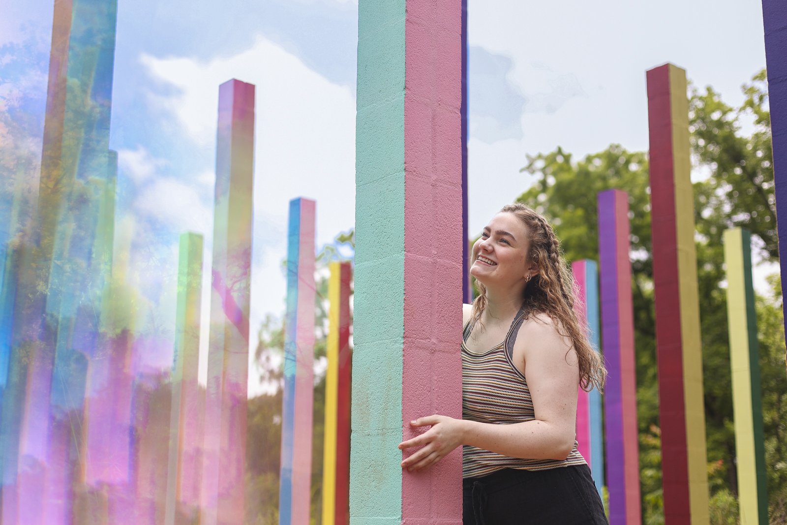 Pearson Smith poses in the “Rainbow Forest” public art installation in Athens, Ga., on June 14, 2023.