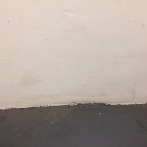 This wall, without a baseboard, speaks volumes about the value of even a most basic baseboard.