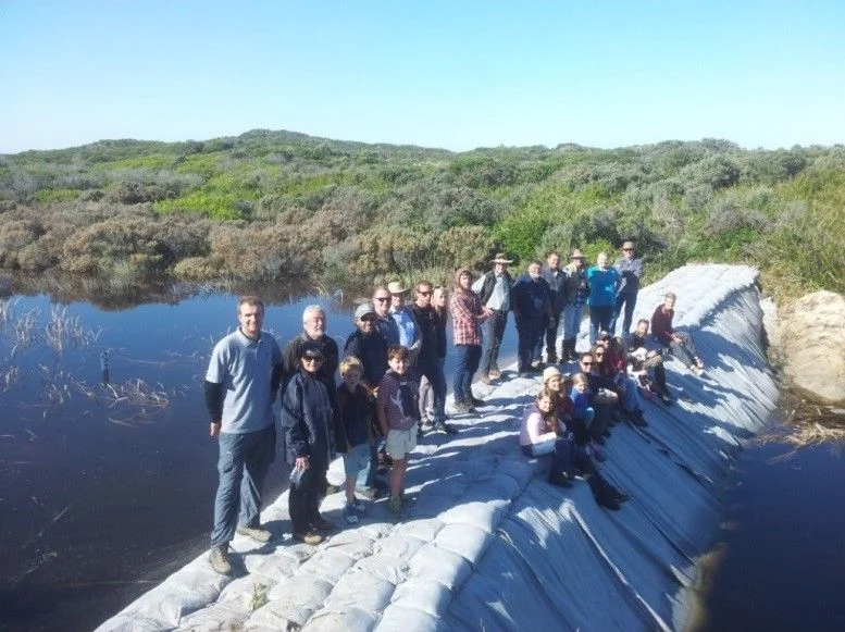 Nature Glenelg Trust staff members celebrate the completion of the third and final sandbag structure with some of the many dedicated volunteers from the local community. (Photo Mark Bachmann)