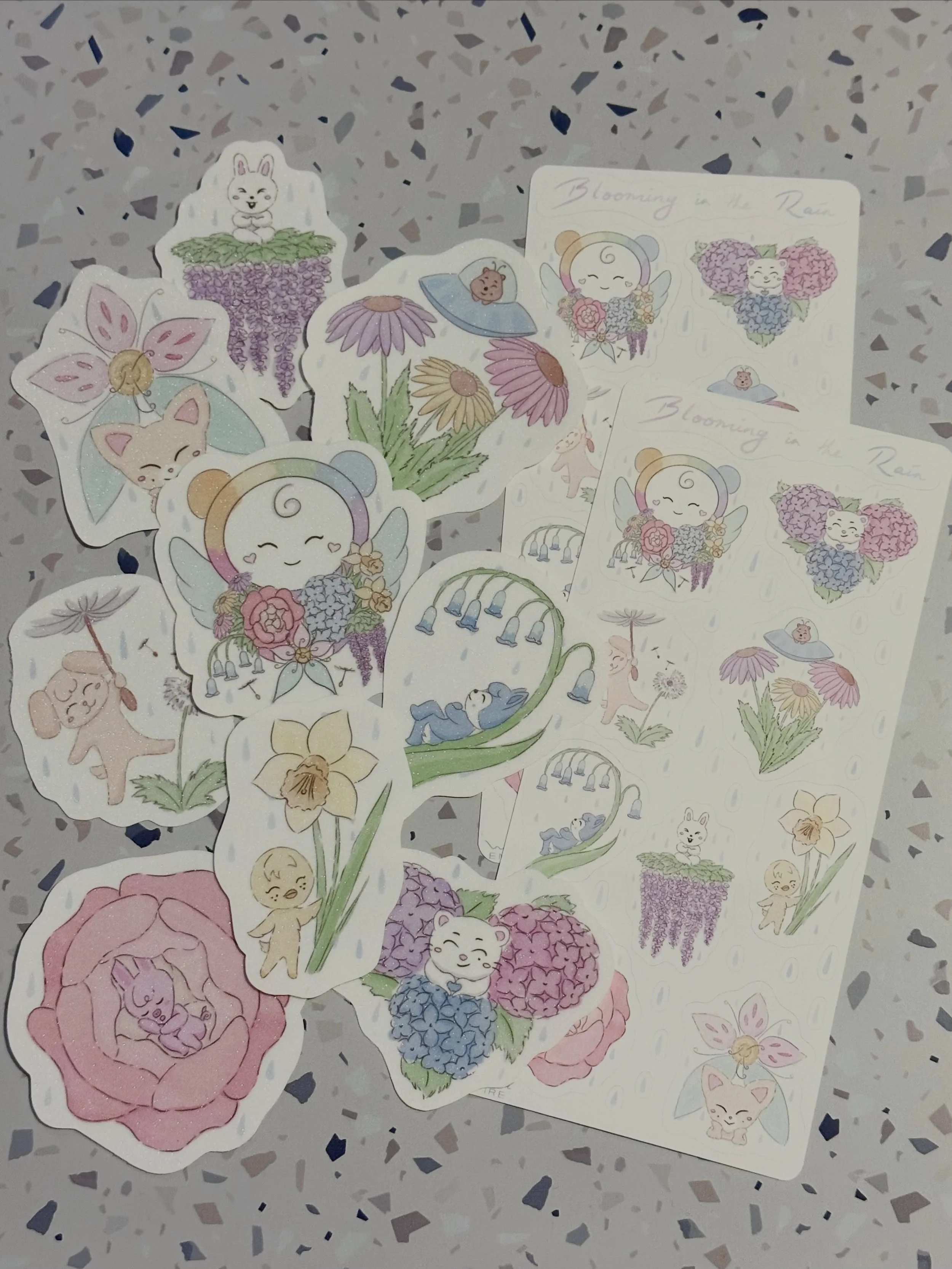 Blooming in the Rain series is here! Diecut glitter lamiated sickers, and printed vinyl sticker sheets! These will be available for purchase at the next Melbourne cupsleeve, and then i will also be listing them up on my website!

I really want to mak