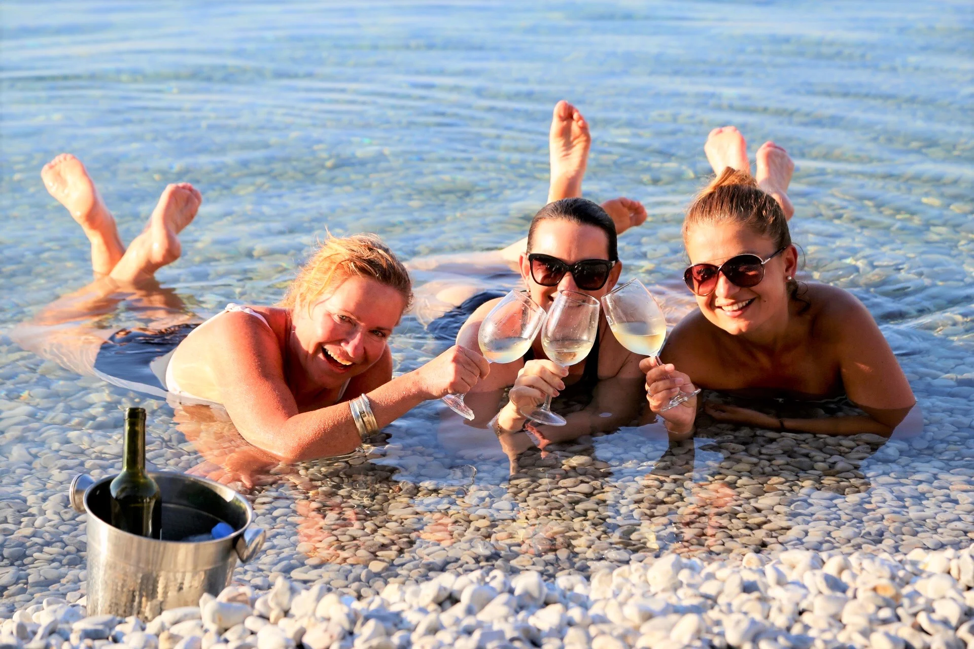 Julie and her friends drinking wine IN the lake. When in Macedonia….