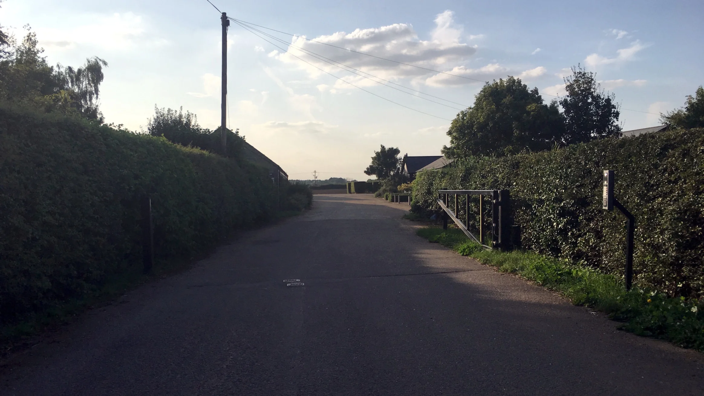 Turn right after the hedge/before the first building