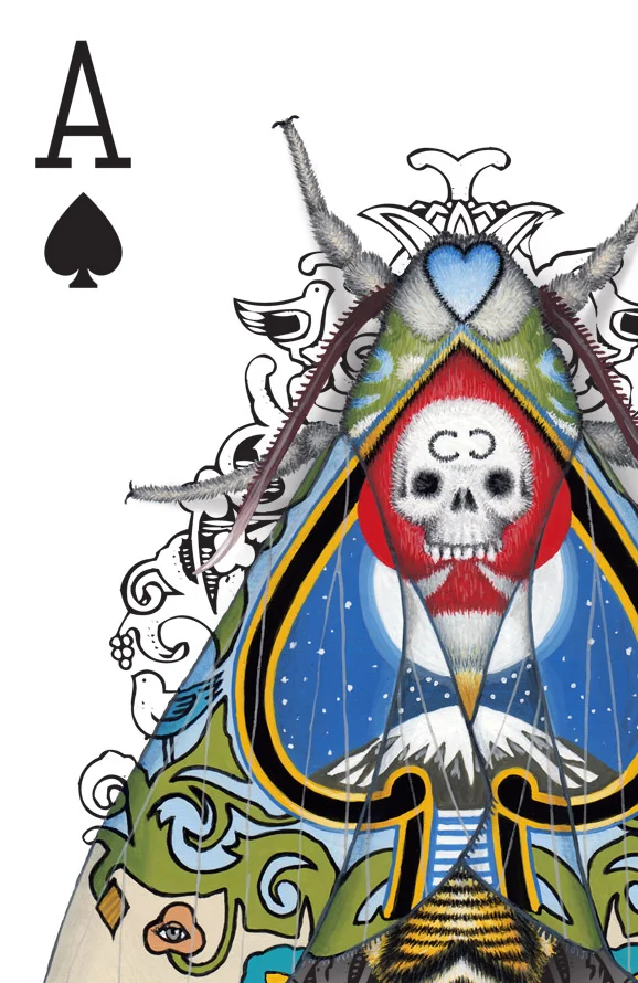 The corner of an Ace of Spades playing card design. The design has been hand-painted with moths that look like they have evolved a wing pattern that camouflages them on the card.