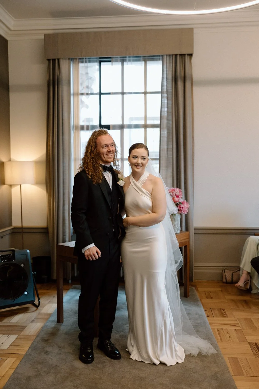 Bride and groom smiling together after getting amrried in the Mayfair Room in Marylebone Town Hall