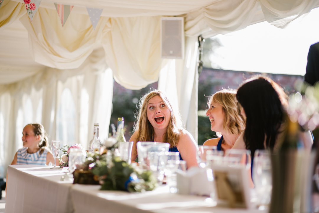 bridesmaid laughing during the wedding speeches 