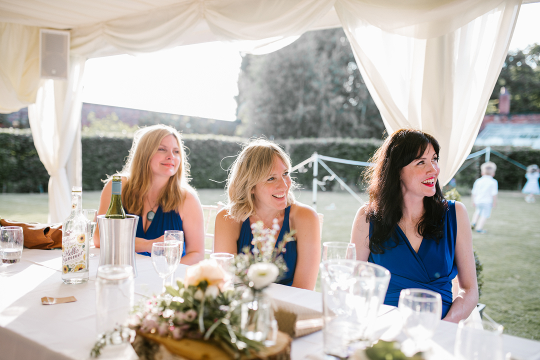 bright natural photo of bridesmaids during the wedding speeches at the walled garden in nottingham
