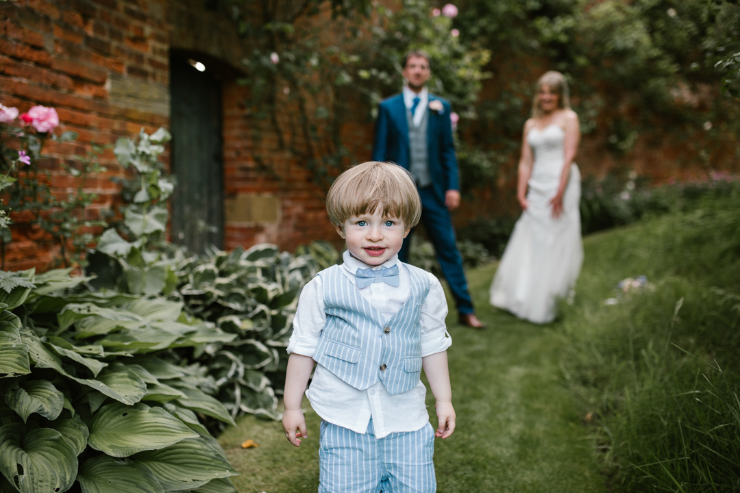 son at his mom and dads wedding dressed in a blue suit 