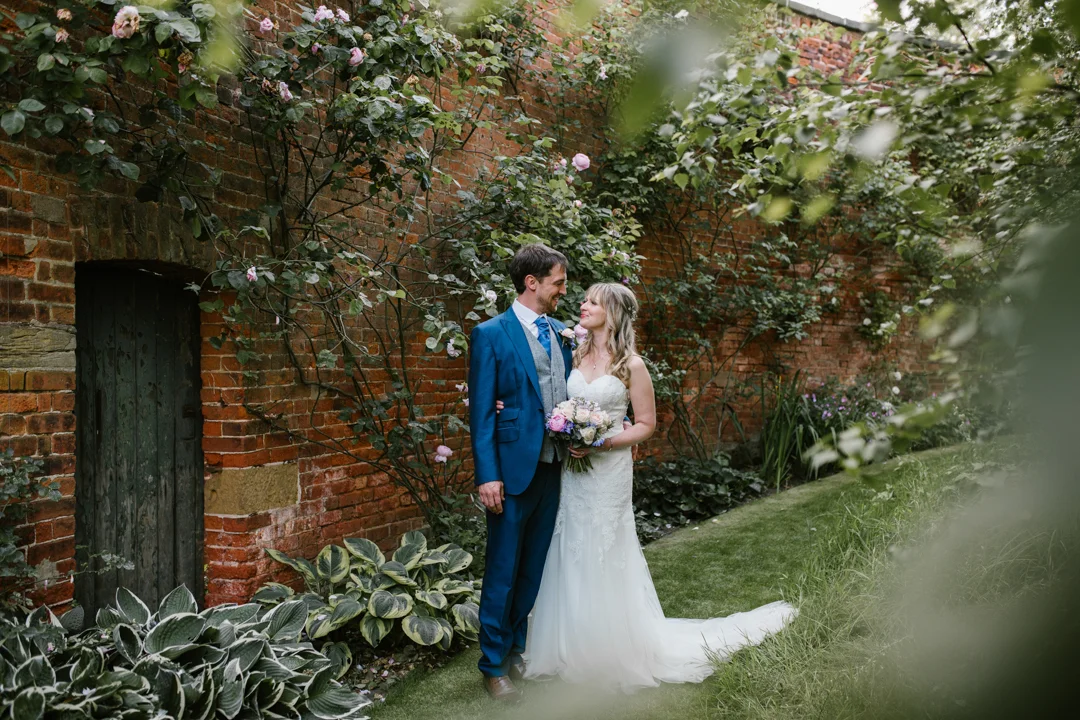 romantic photo of bride and groom at their wedding reception in the walled garden