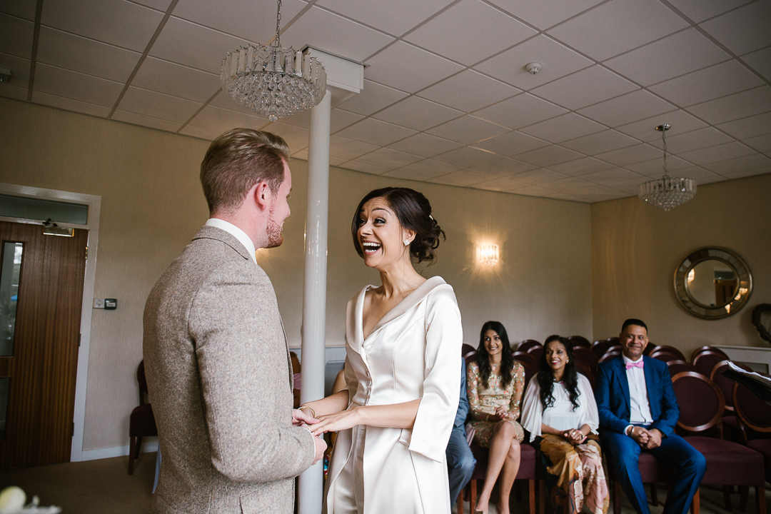 Birde laughing in Lichfield registry office during wedding vows