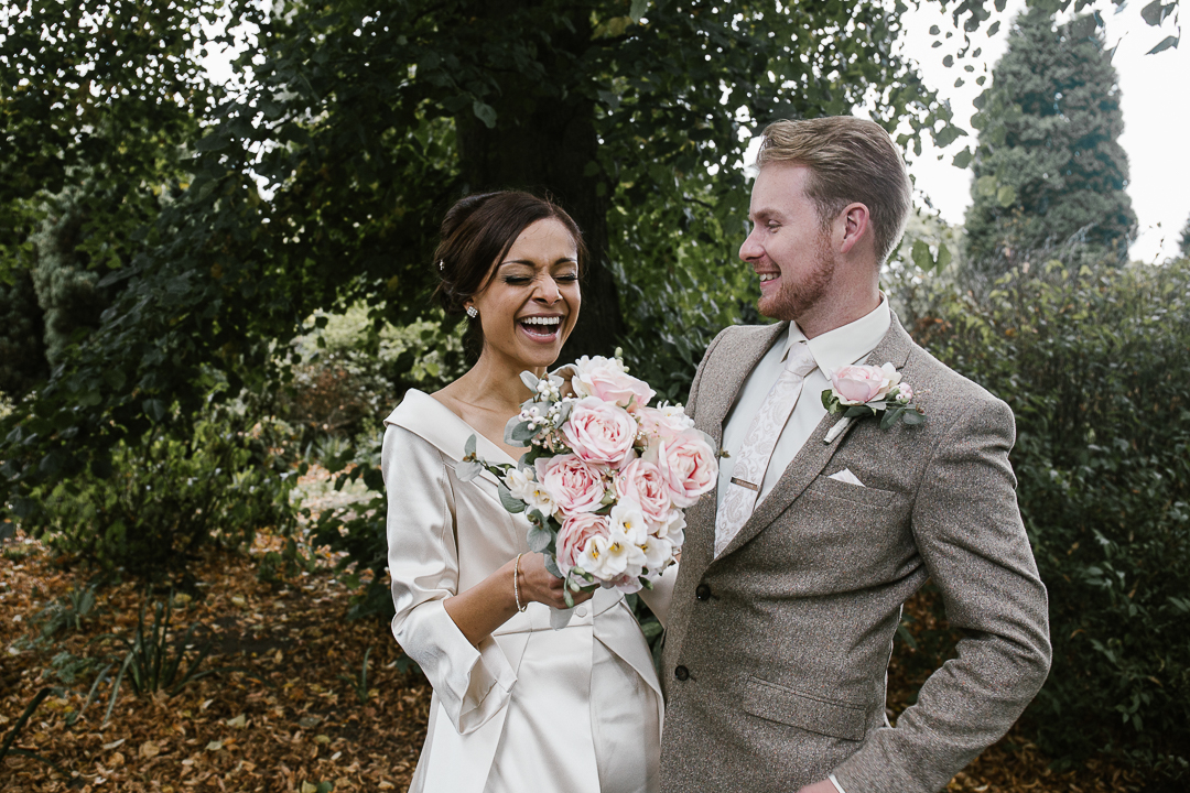 happy natural photo of bride and groom laughing in beacon park - lichfield wedding