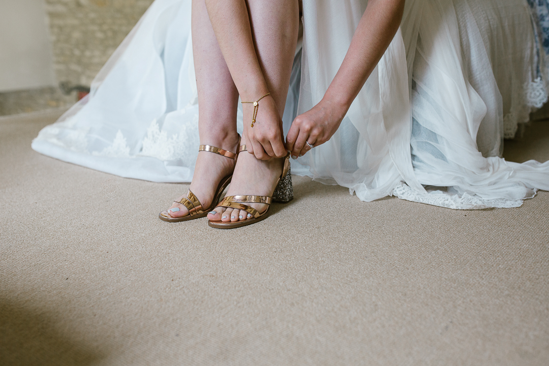 bride as she ties her river island shoes