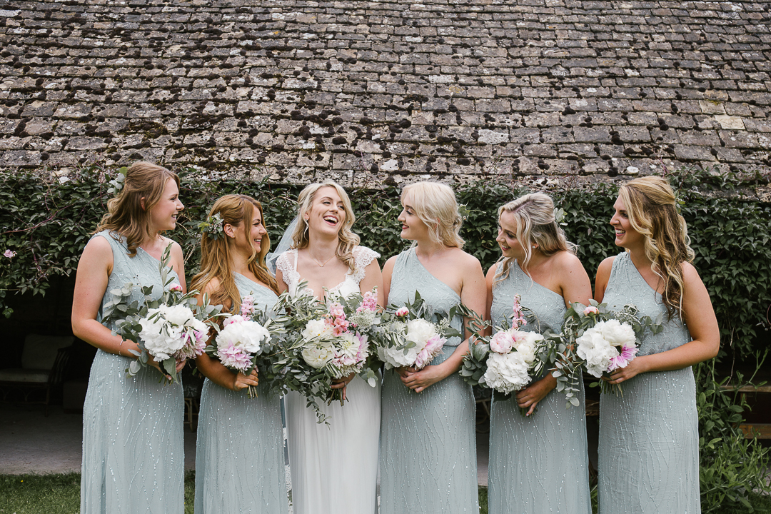 relaxed and natural photo of bridesmaids and bride laughing together of the morning of the wedding at Wildwood Bluebell