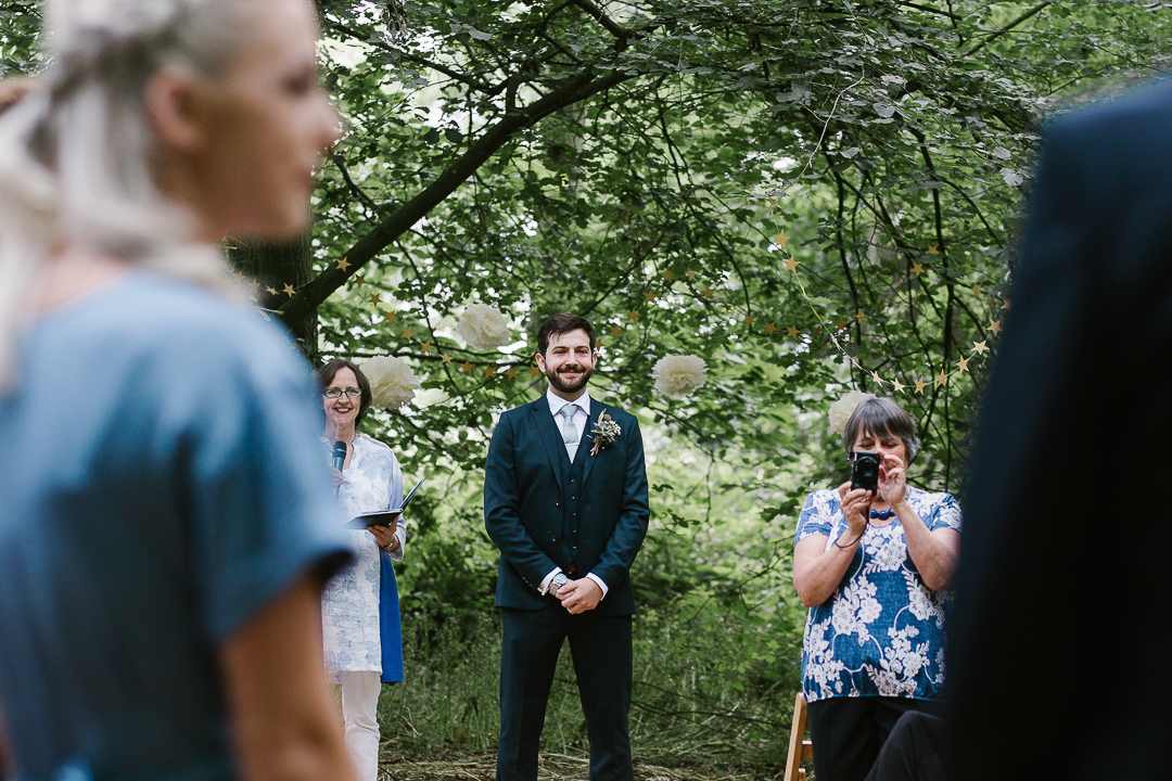 Emotional photo of a groom as he sees his beautiful bride for the first time