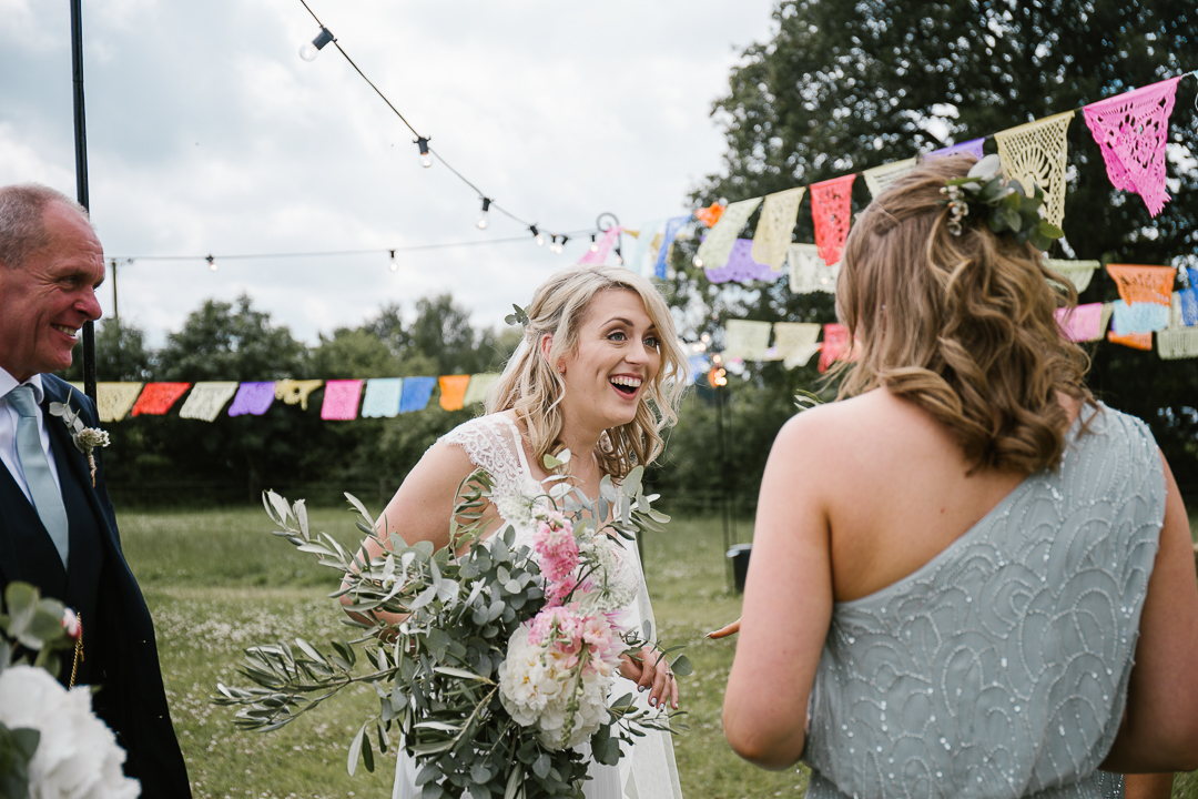 documentary wedding photo of bride laughing after her woodland wedding ceremony
