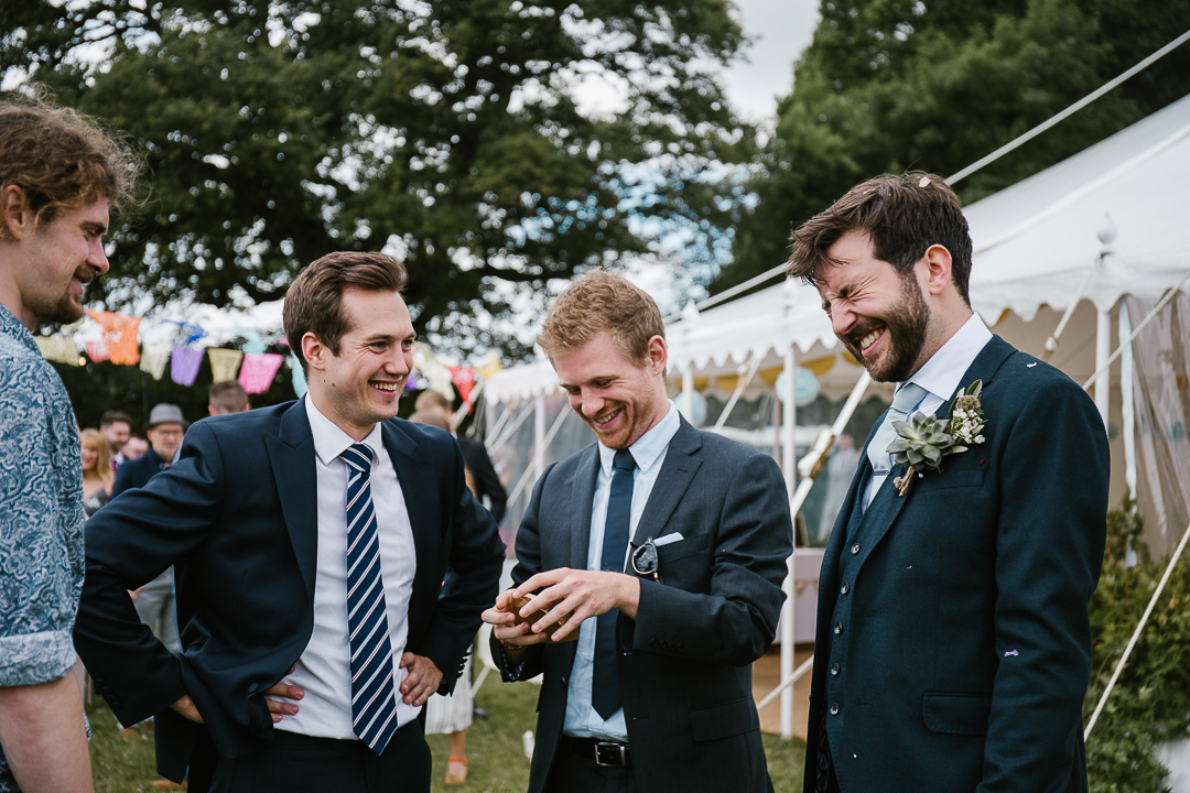 wedding guest throws confetti into the grooms face at his marquee wedding