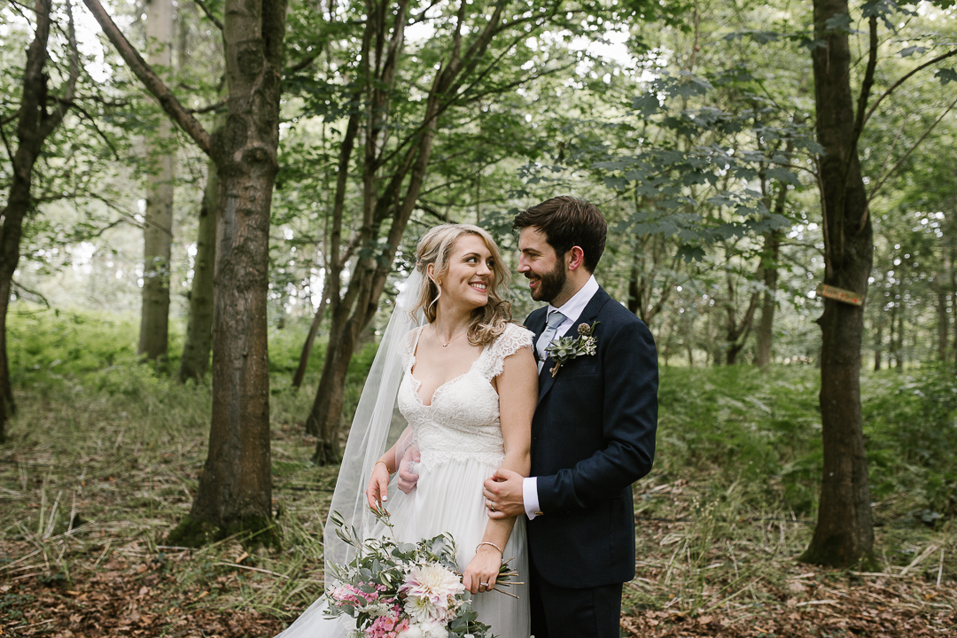 natural photo of bride and groom in the woodlands at Wildwood Bluebell after their outdoor ceremony