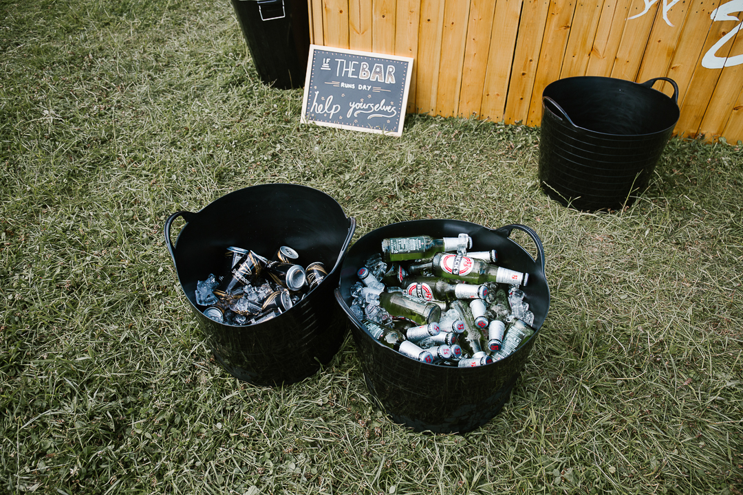 buckets full of beer at a festival wedding in the cotswolds