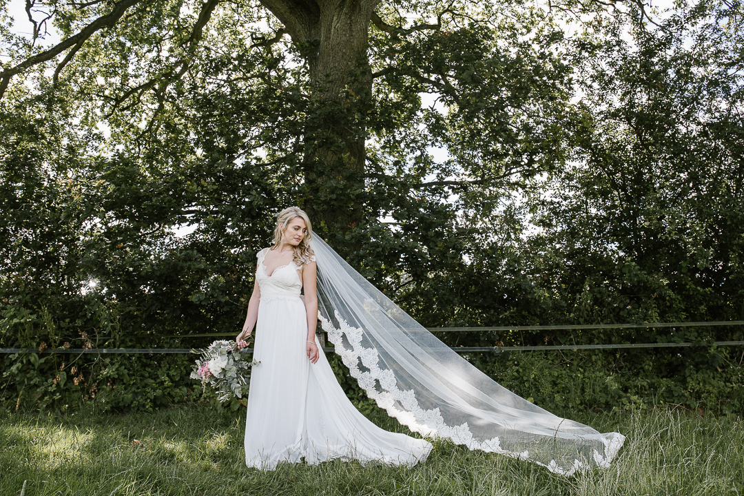 romantic photo of bride in Anna Campbell boho dress and long veil in the forest