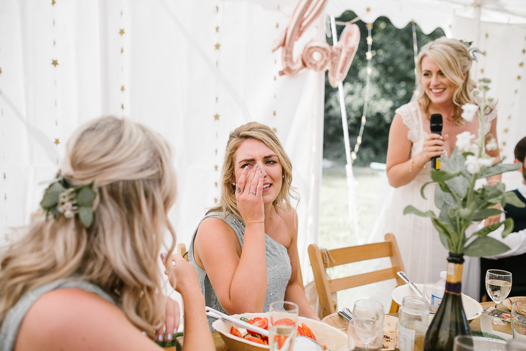 candid photo of bridesmaid crying during the brides wedding speech