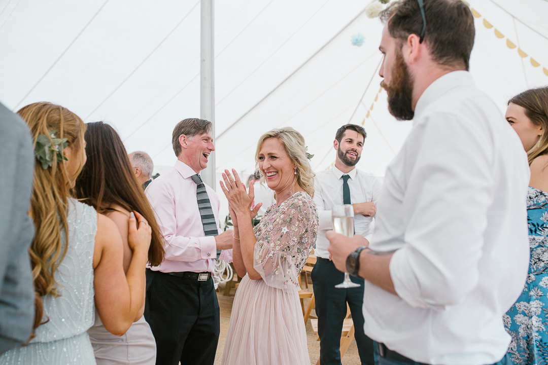 natural photo of the mother of the bride dancing during the live music in the marquee- cotswolds wedding 