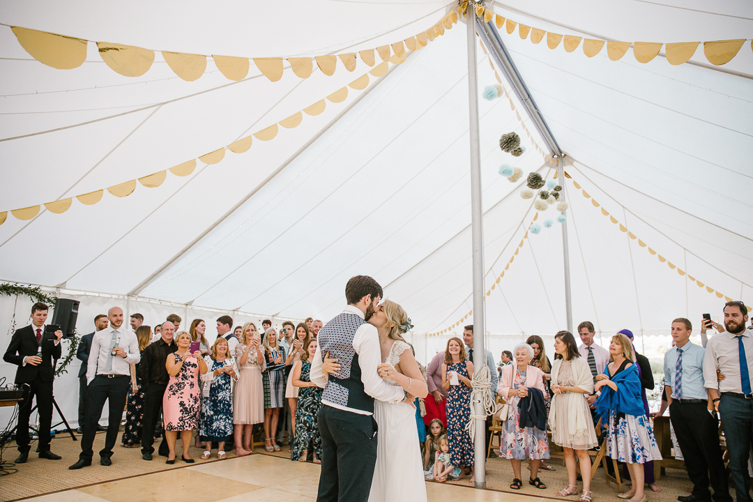 natural photo of bride and groom during their first dance at their festival themed wedding