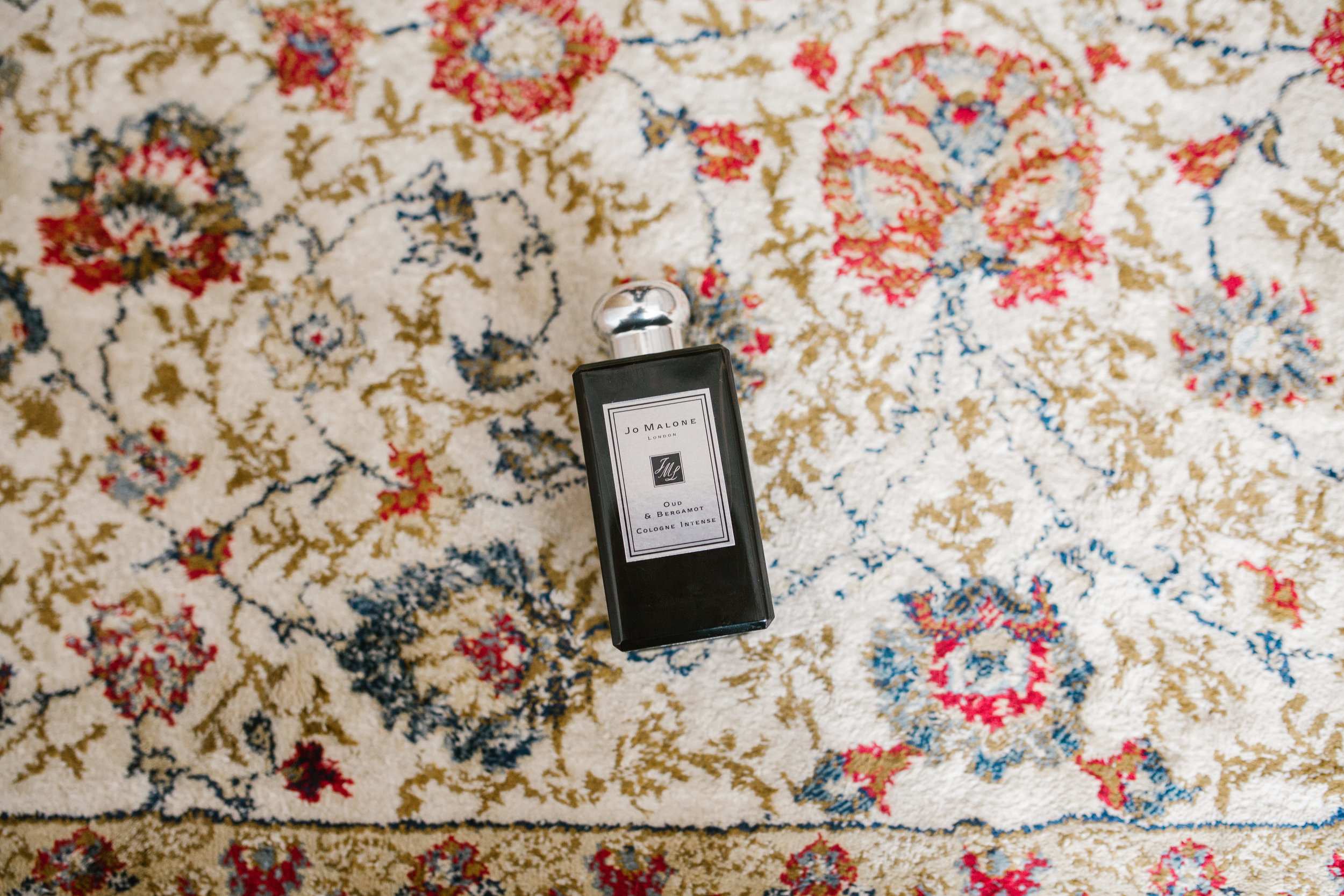 jo malone perfume on patterned carpet