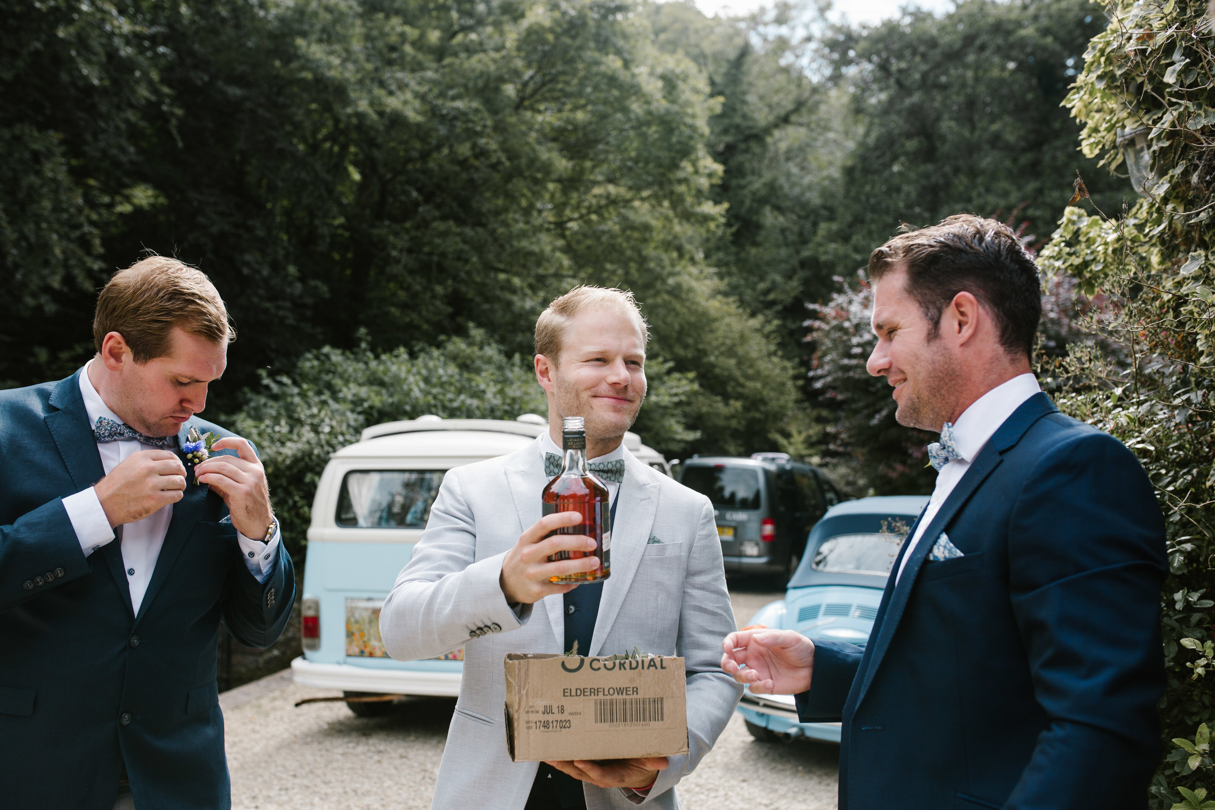 groom and groomsmen having shots on the morning of his wedding