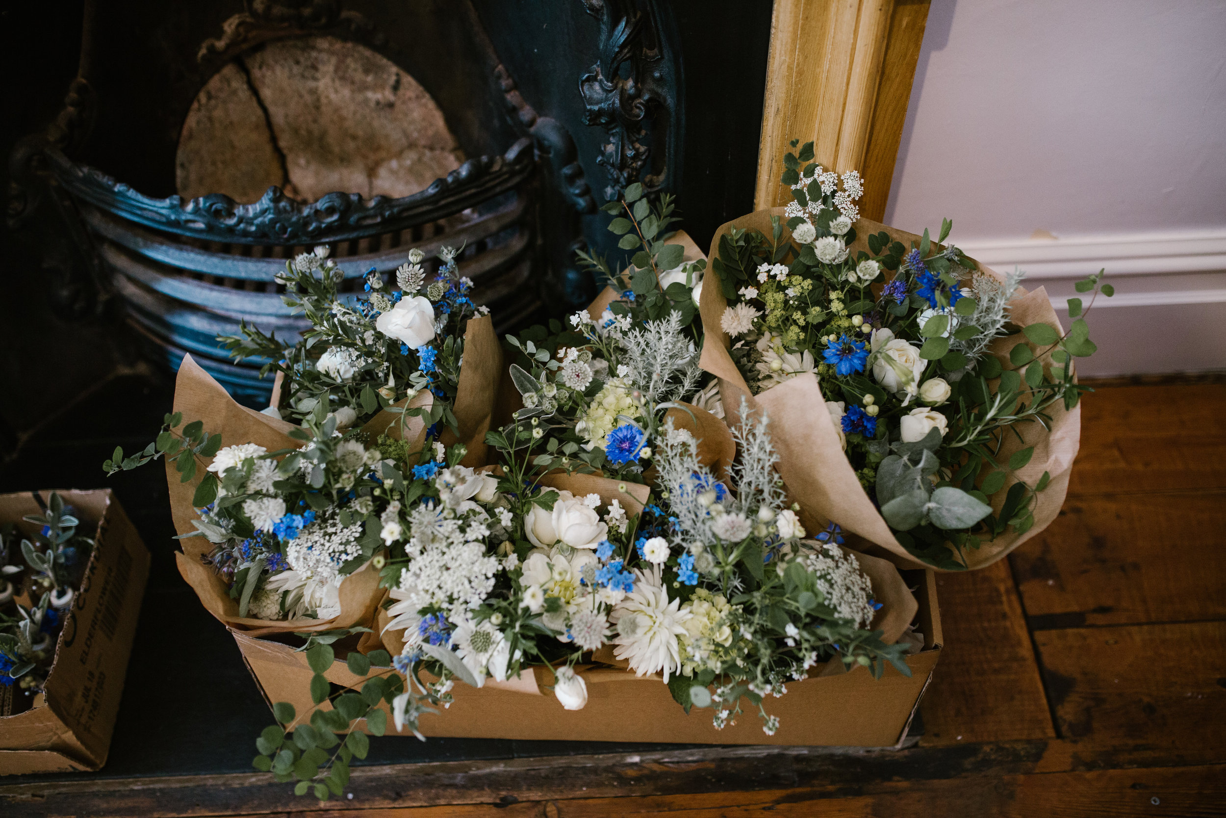 blue wild flowers wrapped in brown paper ready for an outdoor boho wedding