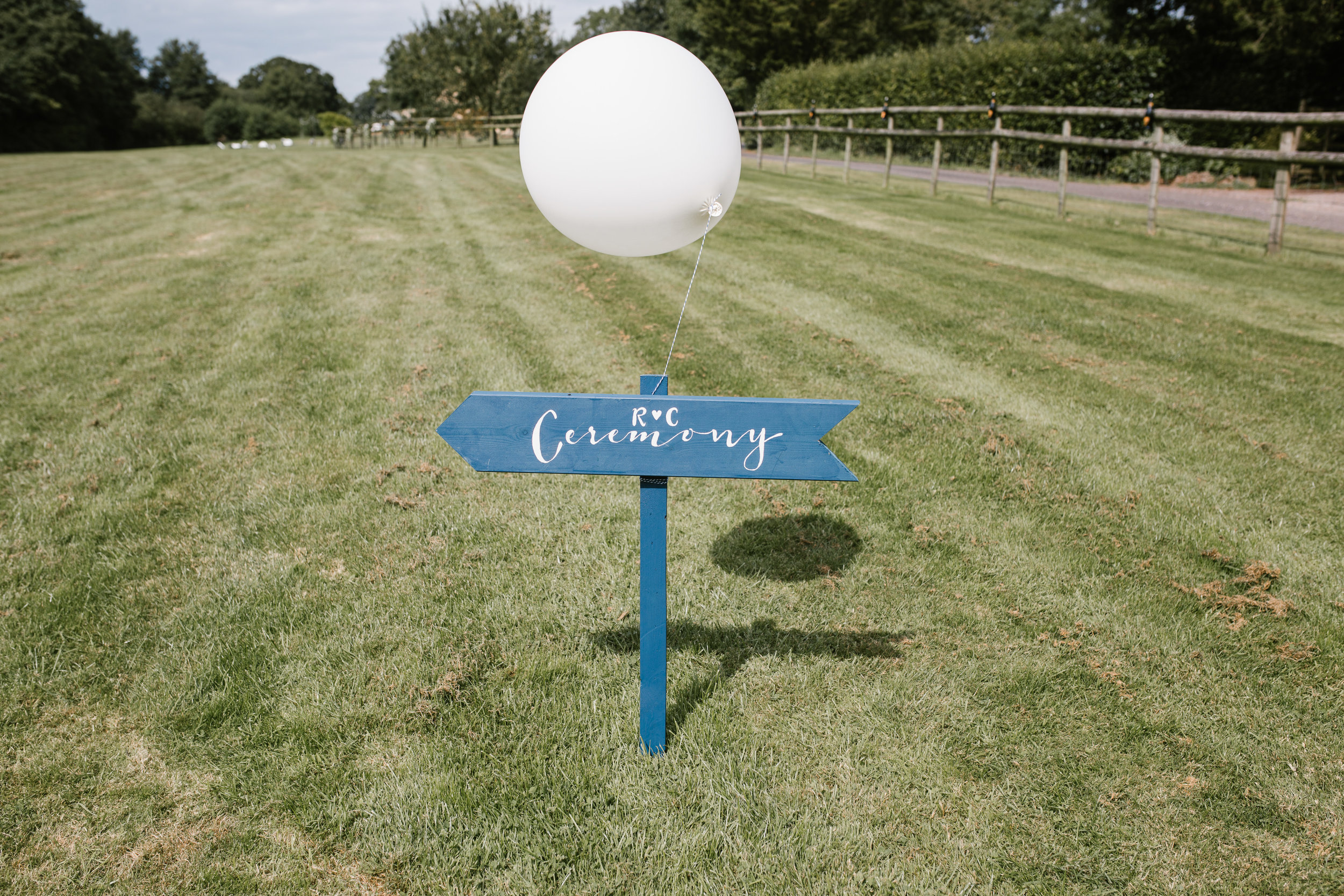 homemade signpost to the outdoor festival wedding