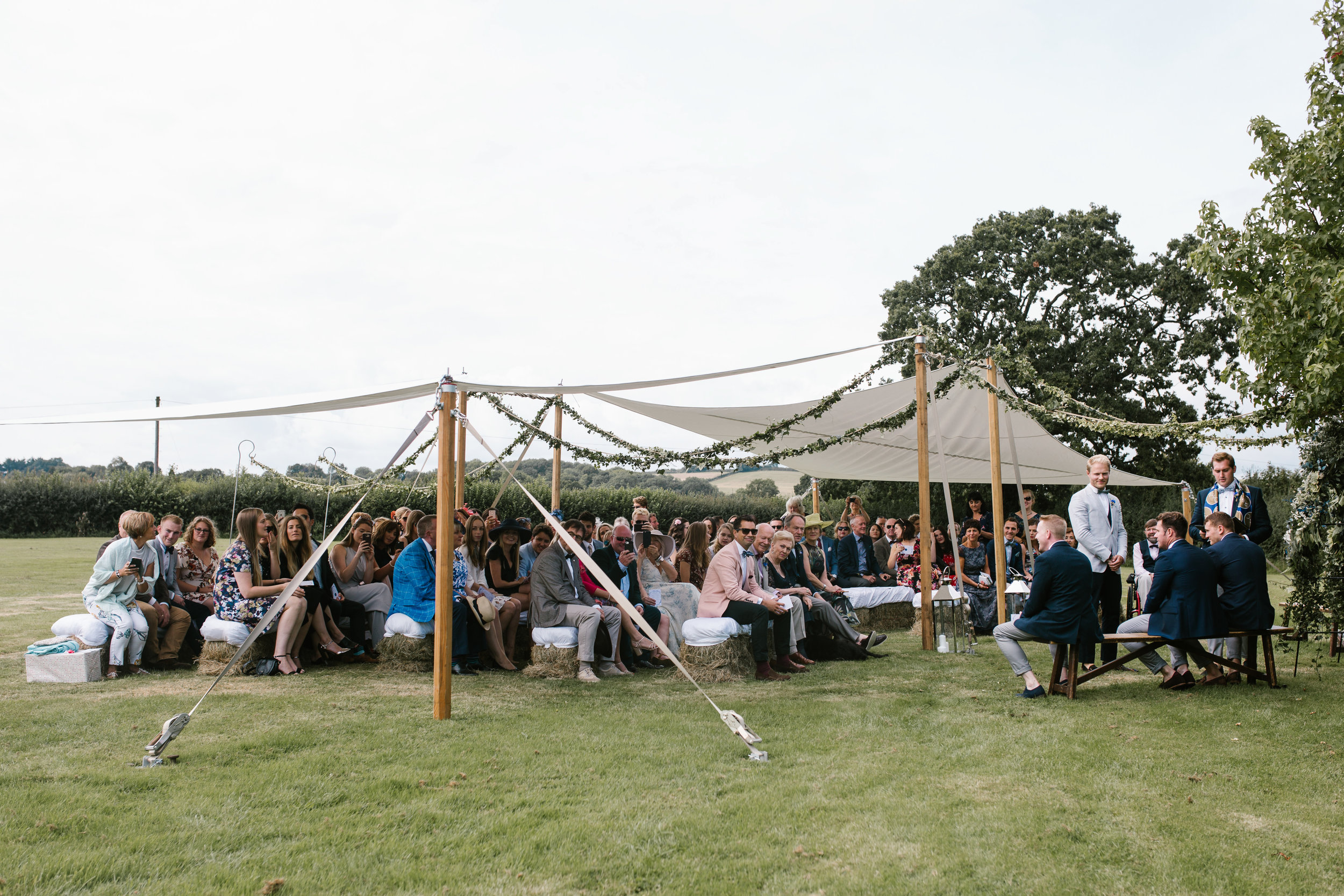 guest gather in the outdoor back garden wedding ceremony