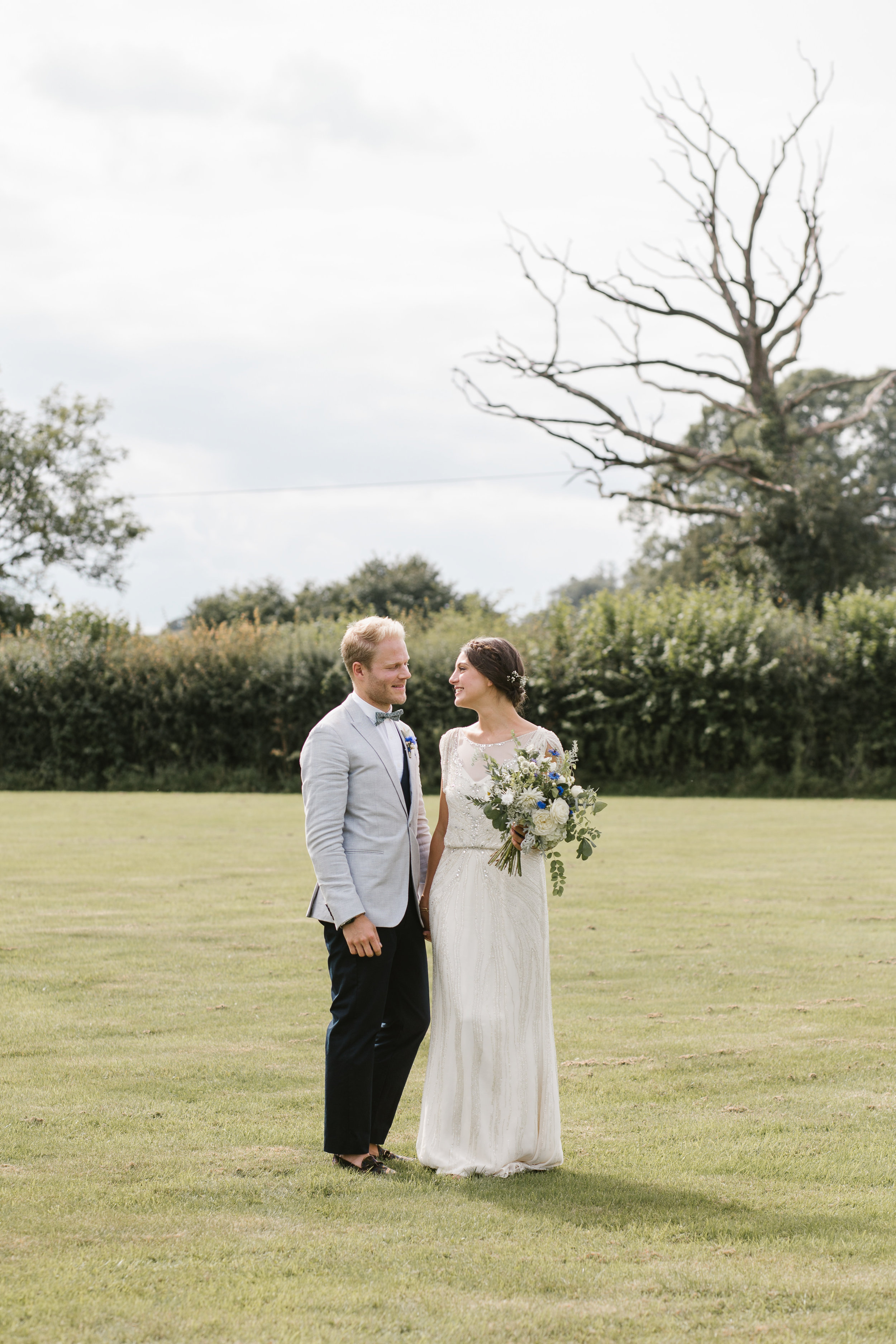 natural photo of newlyweds smiling together after their back garden wedding