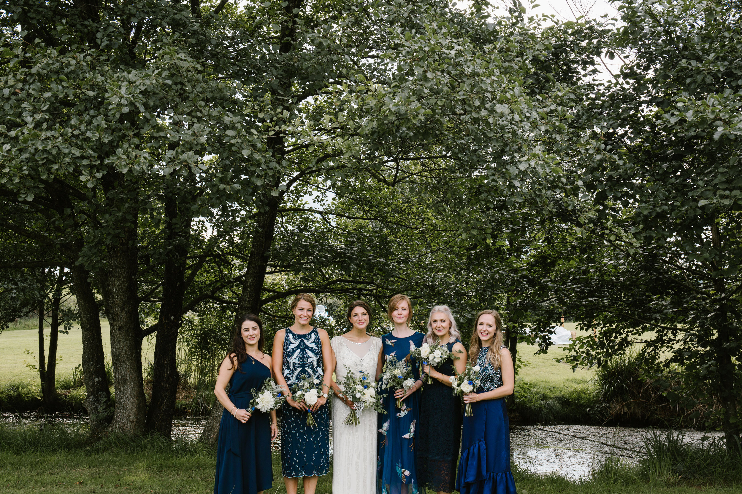 bridesmaids in different kind of dresses 