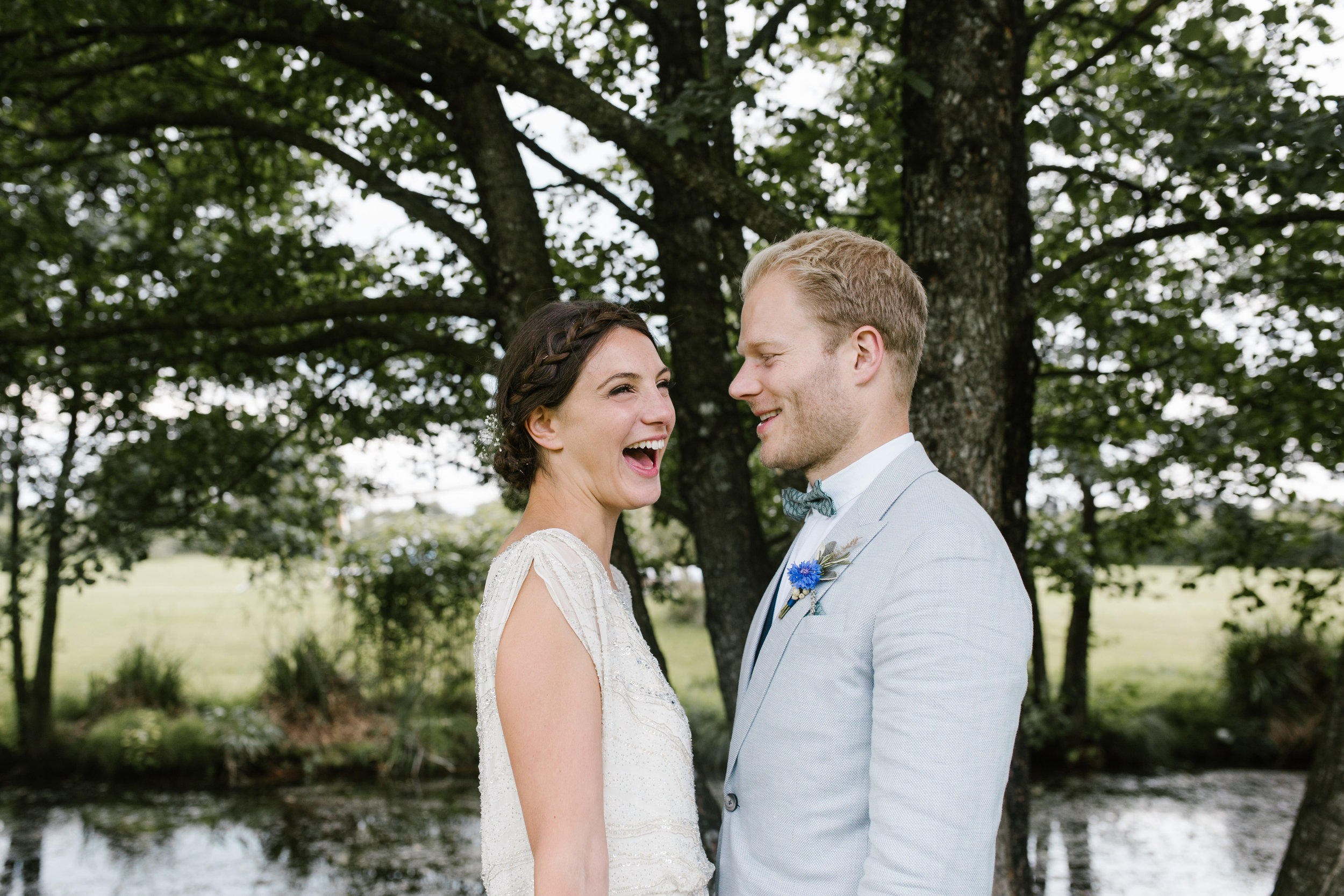 happy photo of boho bride laughing at her husband 