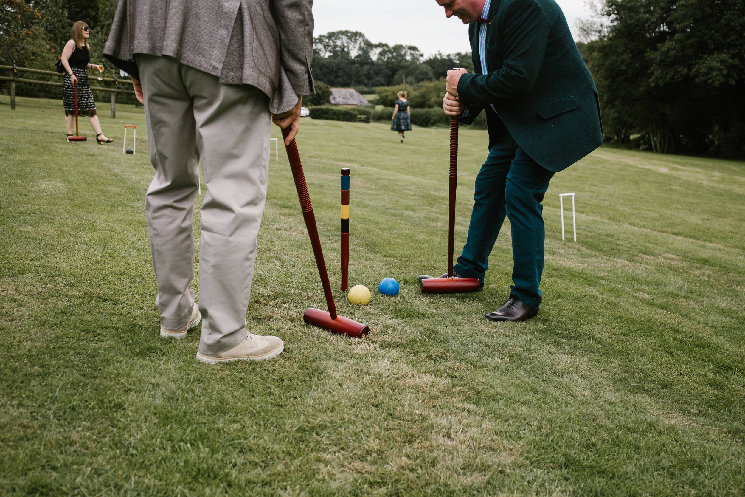 men playing lawn games at outdoor wedding