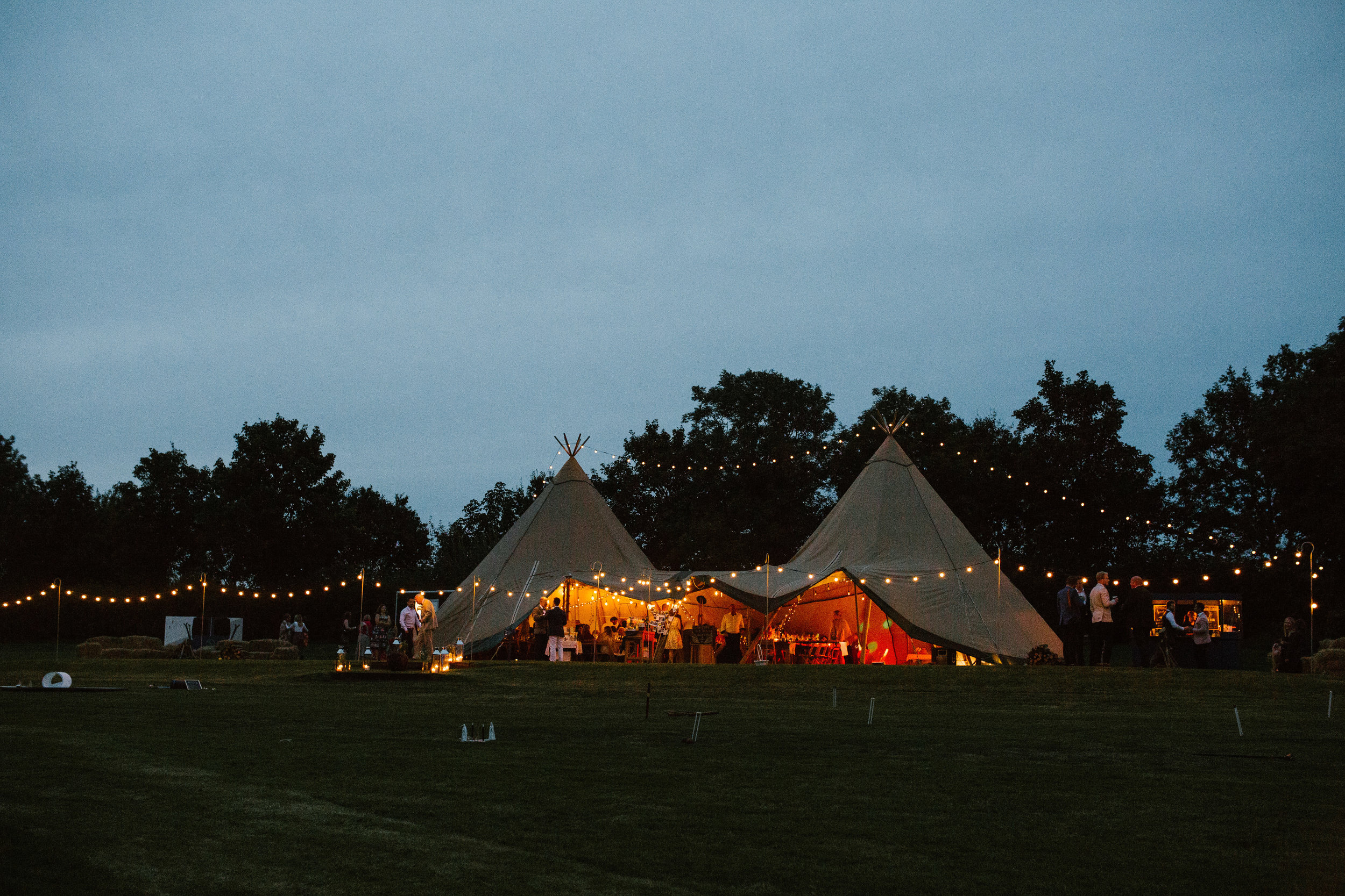 shot of the tipi at night time with the festoon lights creating an atmosphere