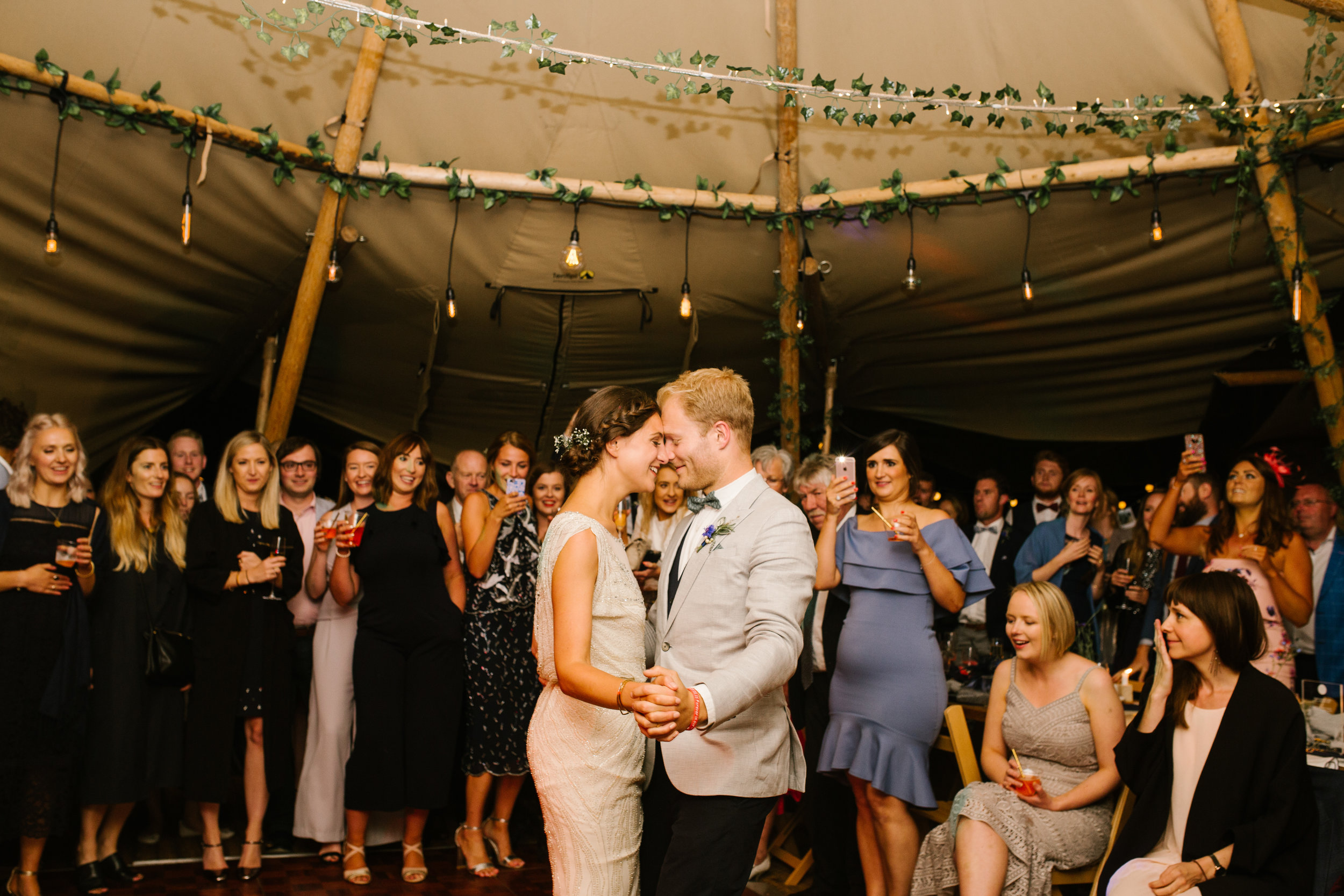 bride and groom dancing together on the dance floor for their first dance in their tipi 