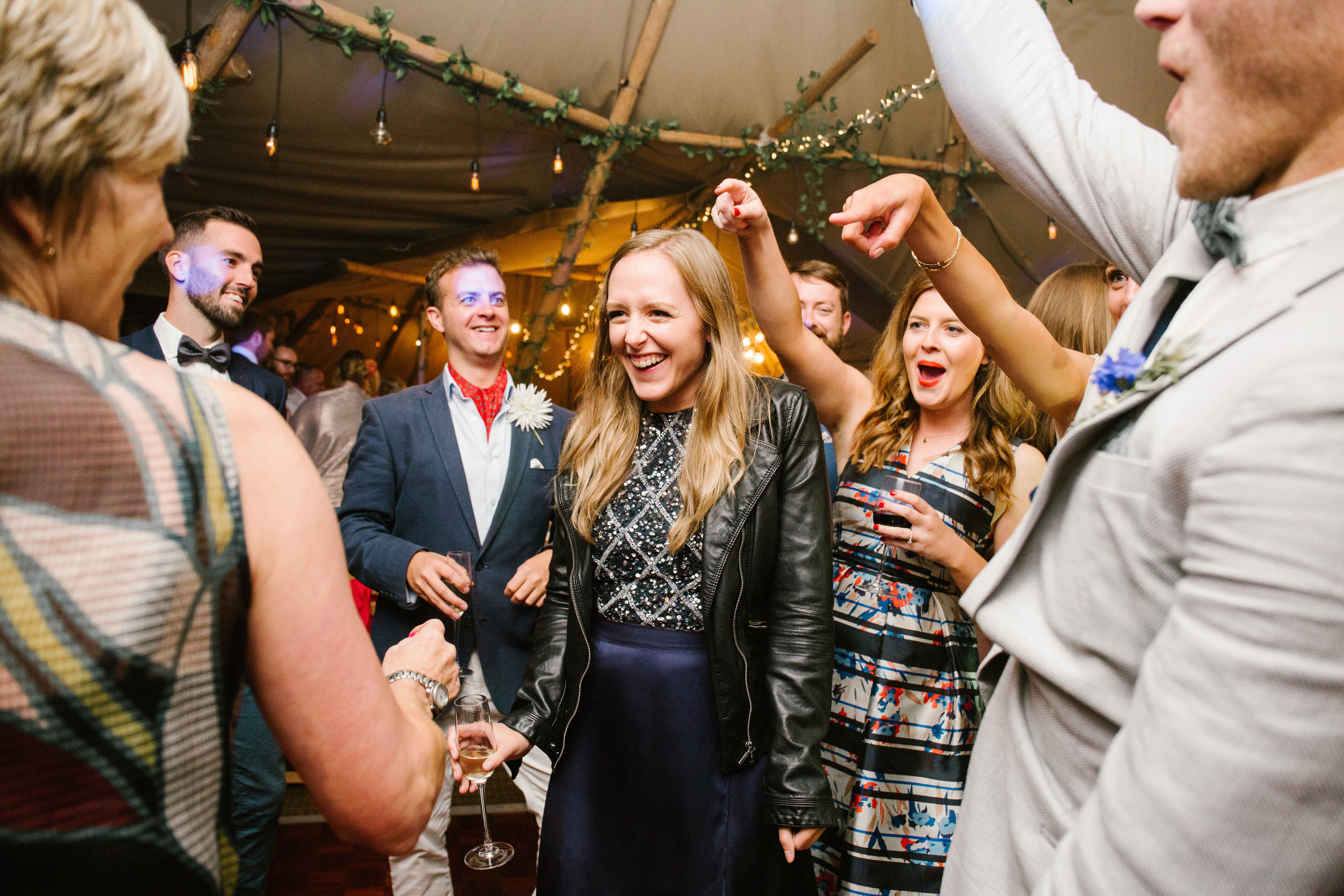 bridesmaid dancing in the middle of the dance floor at a tipi wedding 