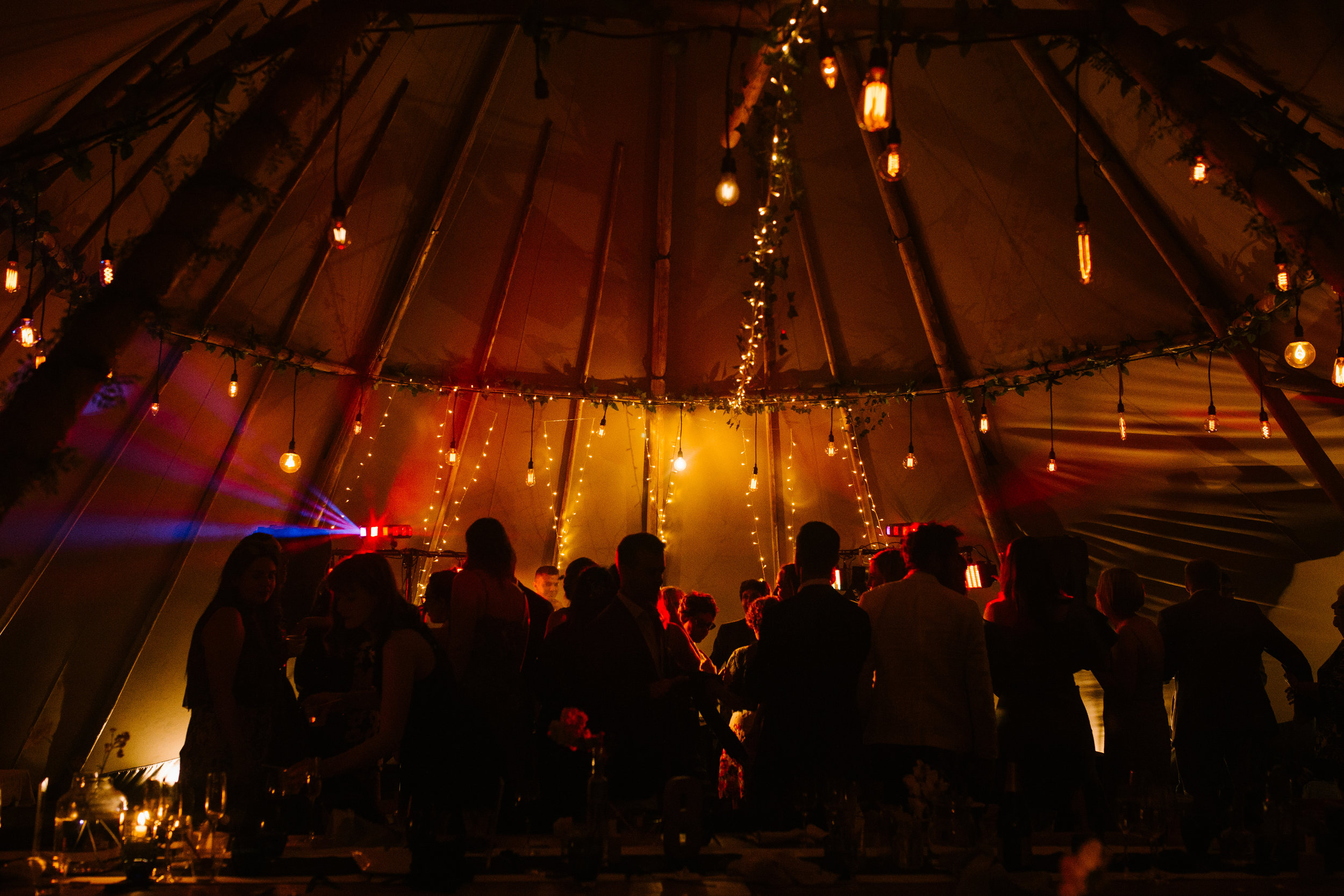 atmospheric shot of the tipi and the dance floor at night time 