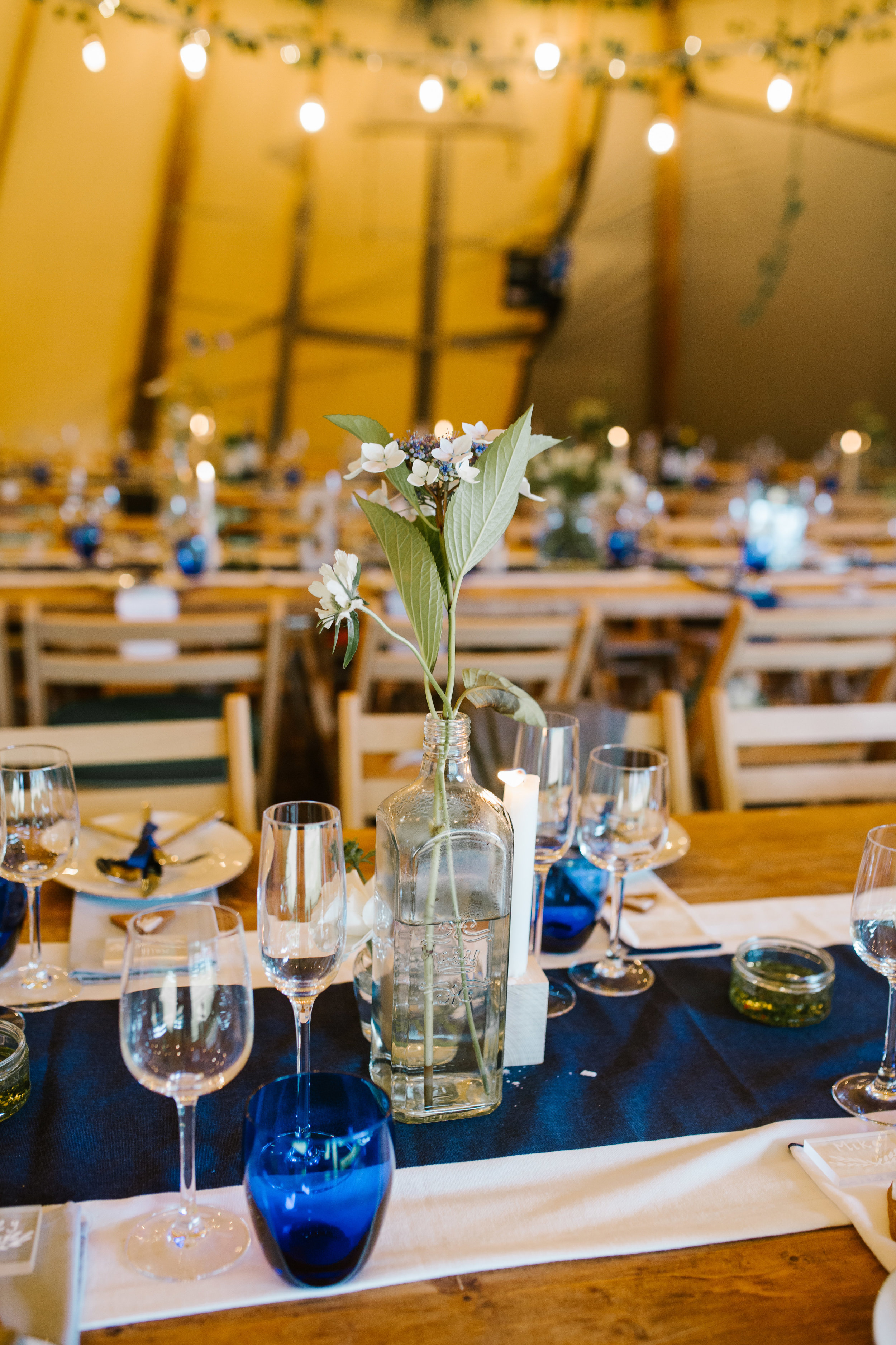 table decorations of a boho themed tipi wedding