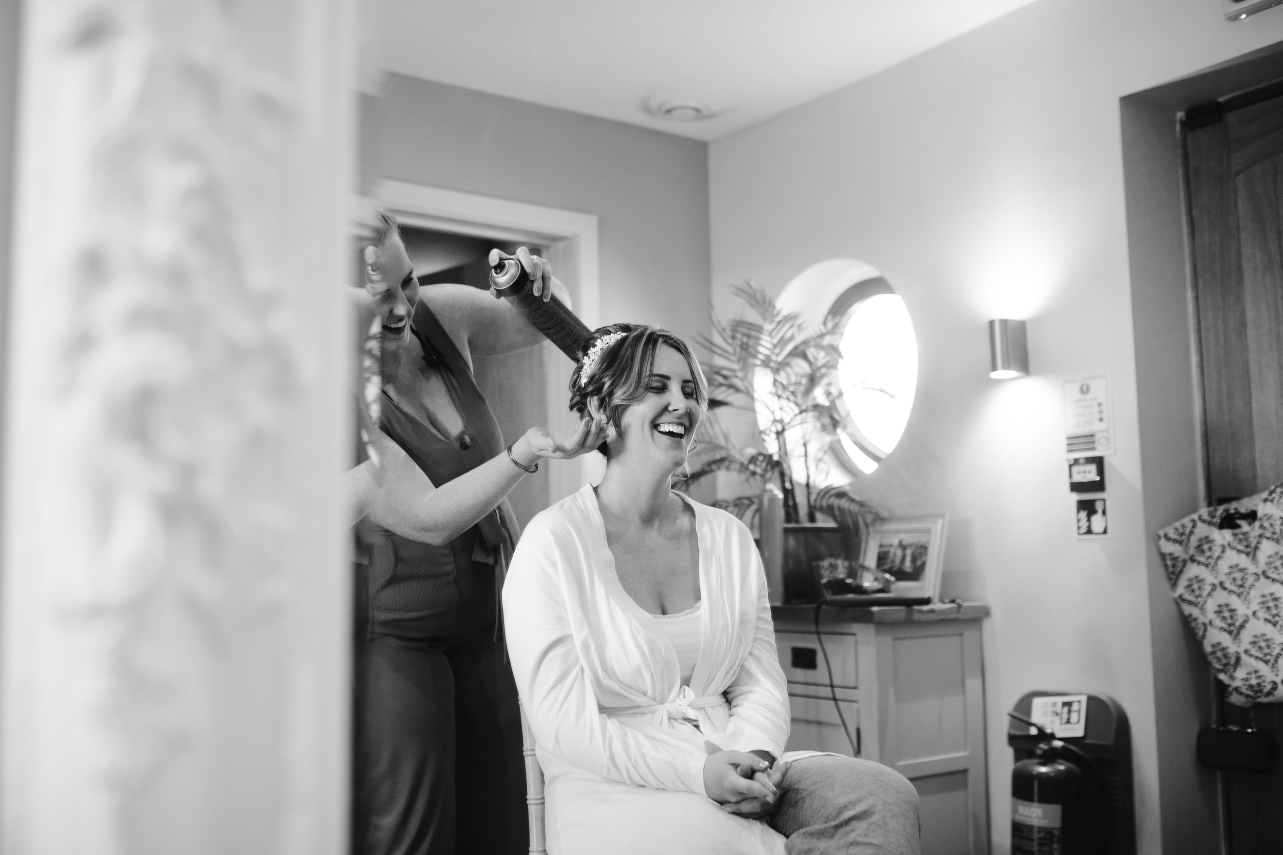 Black and white natural photograph of bride getting ready on the morning of her wedding
