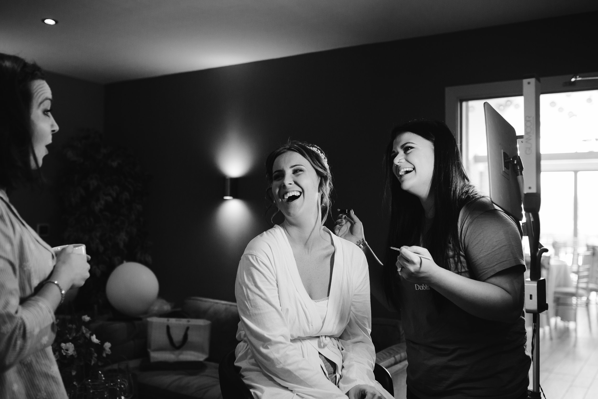 natural photo of bride laughing on the morning of her wedding day 