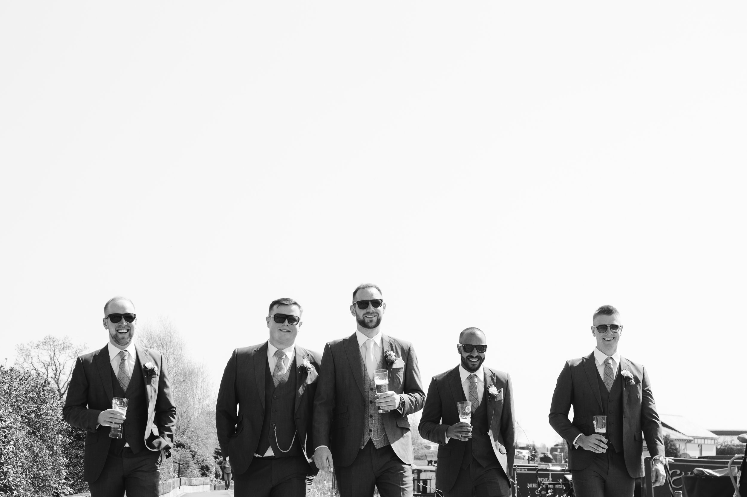 natural black and white photograph of groomsmen at the boat house wedding venue in staffordshire